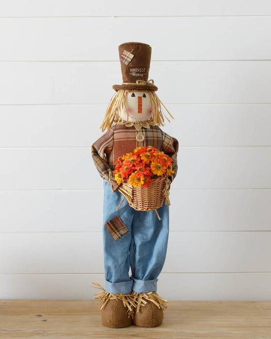 Scarecrow Holding A Basket Of Mums